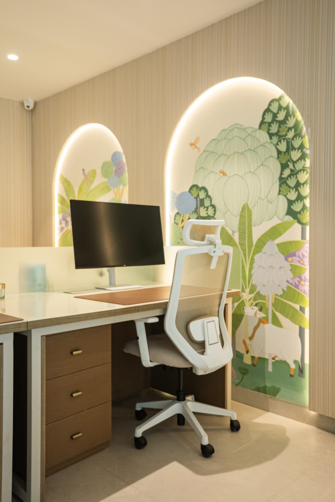 A consult desk under two lit mural arches