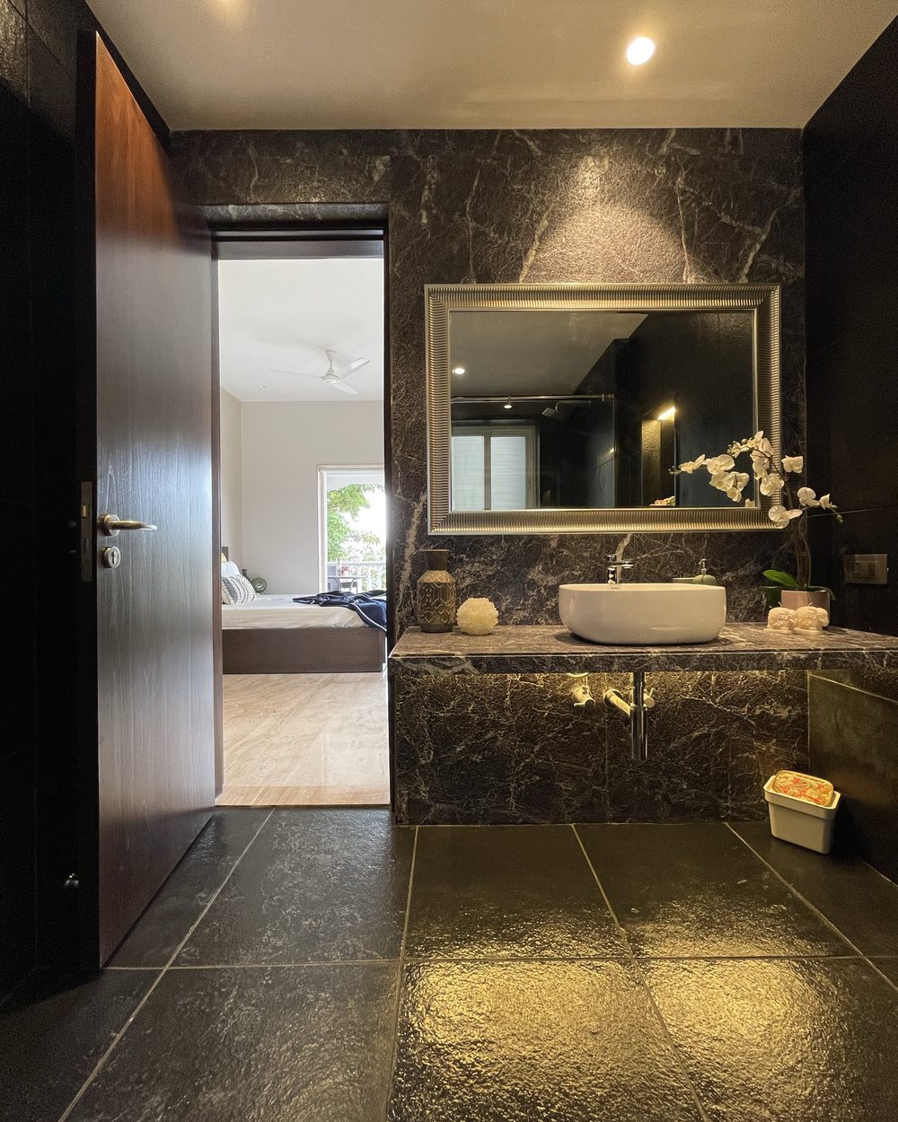 Bathing — dark marble, quiet luxury.